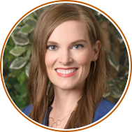 headshot with circular orange background of julie forster
