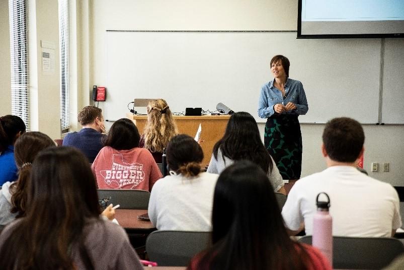 picture of an instructor standing in front of a class teaching