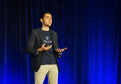 person presenting in front of blue background