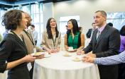 picture of people standing around table networking