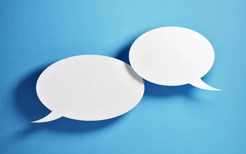 Two white speech bubbles on a blue background.