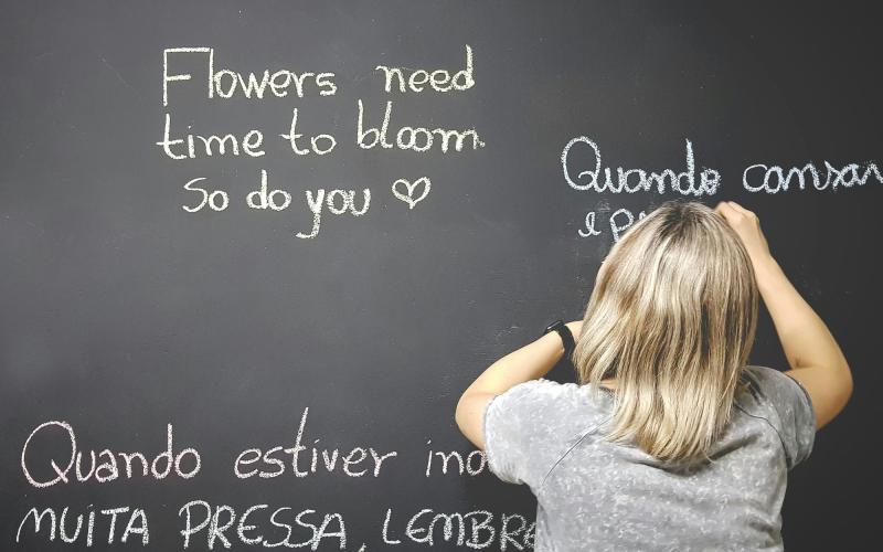 picture of a child writing on a chalkboard